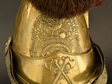 a gold helmet with a fur on top of it