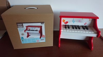 a red piano and a box on a table