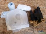 a bag of toilet paper next to a couple of valves on the floor