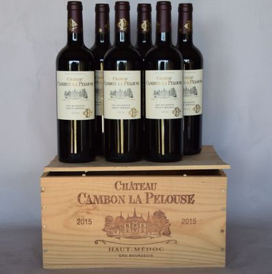 six bouteilles de vin se trouvent dans une caisse en bois posée sur une table