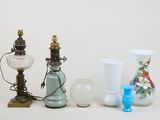 three different vases and a lamp on a table