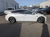 the white car is parked in the parking lot next to other cars