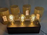 five light bulbs that are on a wooden stand