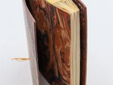 an open book sitting on top of a table next to a white background