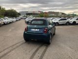 cars parked in a parking lot with a cloudy sky in the background