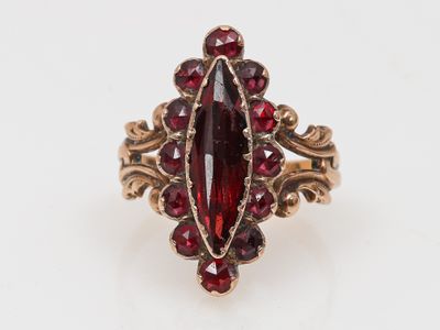 Gros plan sur une bague contenant une pierre rouge