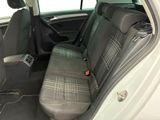 the back seats of a white car with a black seat belt