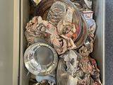 an open box filled with various items sitting on top of a carpeted floor