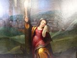 un tableau représentant une femme tenant une croix dans un champ