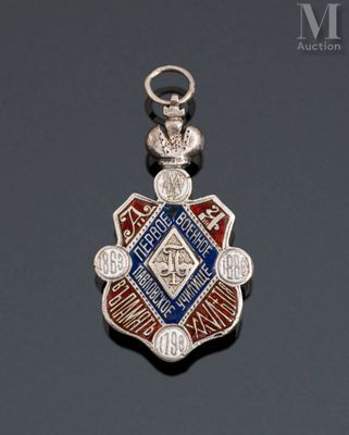 a close up of a silver and blue medal on a black surface