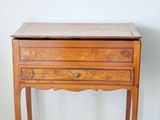 a small wooden table with a drawer on top of it