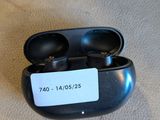 a pair of black ear buds sitting on a table