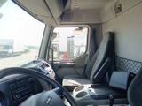 a view of the inside of a truck from the driver ' s seat