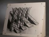 a black and white picture of a piece of art on a table