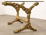 a close up of a table with a glass top on a cement floor