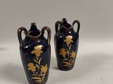 two vases that are sitting on a table