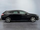 the black car is parked on the concrete floor in the room