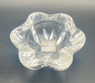 a clear glass bowl on a table with a black background