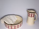 a pitcher and a bowl sitting next to each other on a table