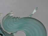 a glass sculpture of a wave coming out of the ocean