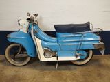 a blue and white motor scooter parked in a garage