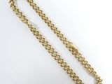 a close up of a gold chain on a white background