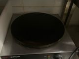 a stove top with a pan on it in a kitchen