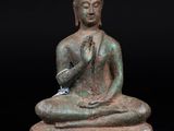 an image of a statue of a person sitting on top of a table