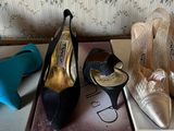 several pairs of women ' s shoes are sitting on top of a box