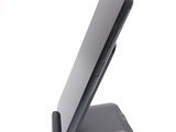 a cell phone on a stand on a white surface
