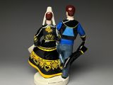 figurines of a man and a woman dressed in traditional clothing