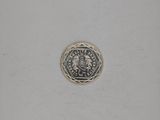 a close up of a coin on a white surface