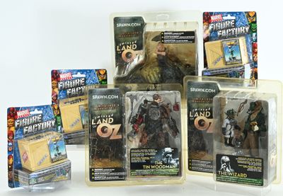 five action figures of different sizes and colors in the package