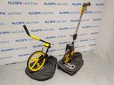 yellow and black metal detector with a black bag and a yellow wheel