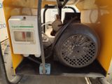 a machine that is sitting in the back of a truck