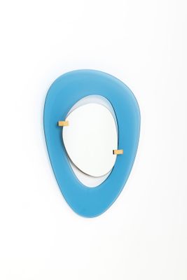 a mirror on the wall with a blue triangle on it
