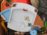 a toy boat that is in a box with other toys
