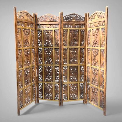 an image of a room divider made of wood with intricate carvings