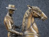 a statue of a man riding a horse with a hat on