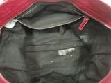 the inside of a red purse with a zipper on it