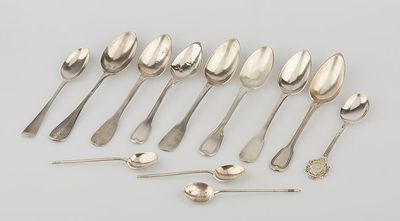 a group of silver spoons and spoon spoons on a table