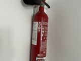 a red fire extinguisor hanging on the wall