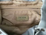 the inside of a prada purse with a tag on it