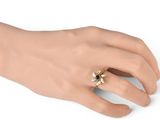 a close up of a person ' s hand with a ring on it