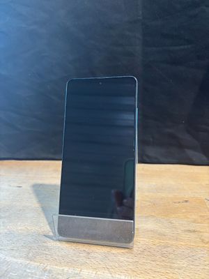 an image of a cell phone sitting on top of a wooden table