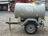 a trailer with a tank attached to it in a parking lot