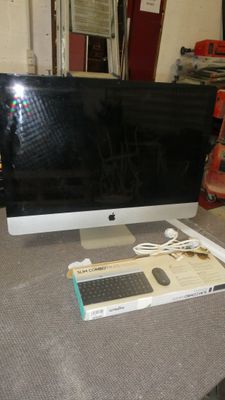 an apple computer sitting on top of a table next to a keyboard