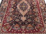 an antique persian rug with a large medallion design