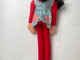a doll that is sitting on a white surface