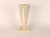 a white vase sitting on a table with a white background